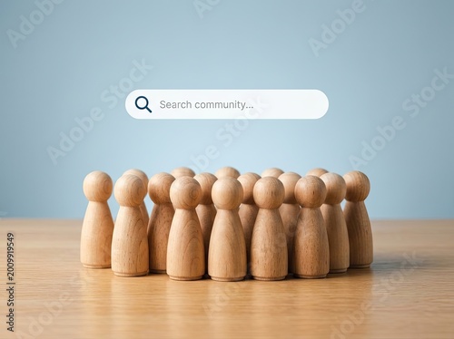 Wooden figurines arranged in a group with a search bar, on a wood surface, with a blurred blue background, Teamwork Concept.