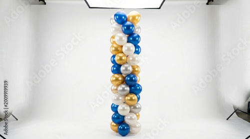 Colorful balloon spiral column for decoration in a studio setting with copy space