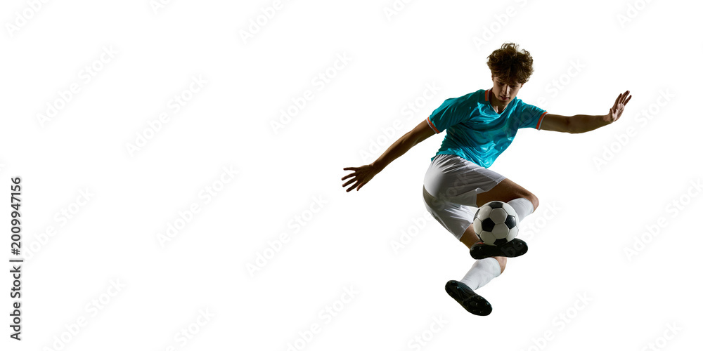 Obraz premium Soccer player flying with ball under foot in wide copy space composition. Concept of sports banner, football campaign, dynamic training content, product ad layout and explosive energy.