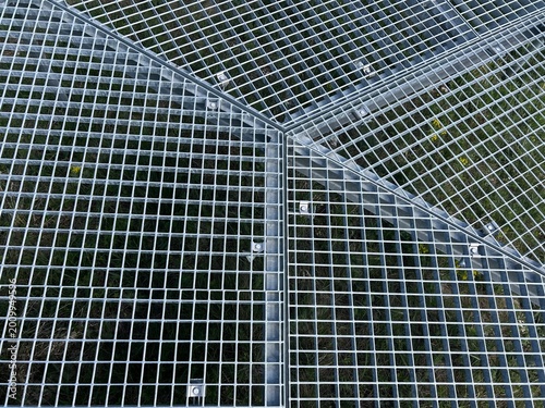 Mesh artificial background. Top view on metal grate floor with sections.