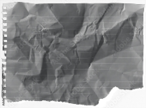 A crumpled gray notebook sheet with lined paper and a torn edge on a flat surface