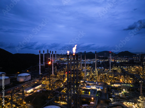 Illuminated Petrochemical Refinery Facility Operating Under Blue Hour Twilight Sky