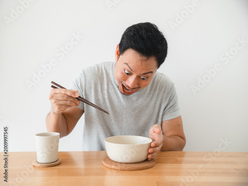 Excited individual reacting to spicy challenge with surprise and humor