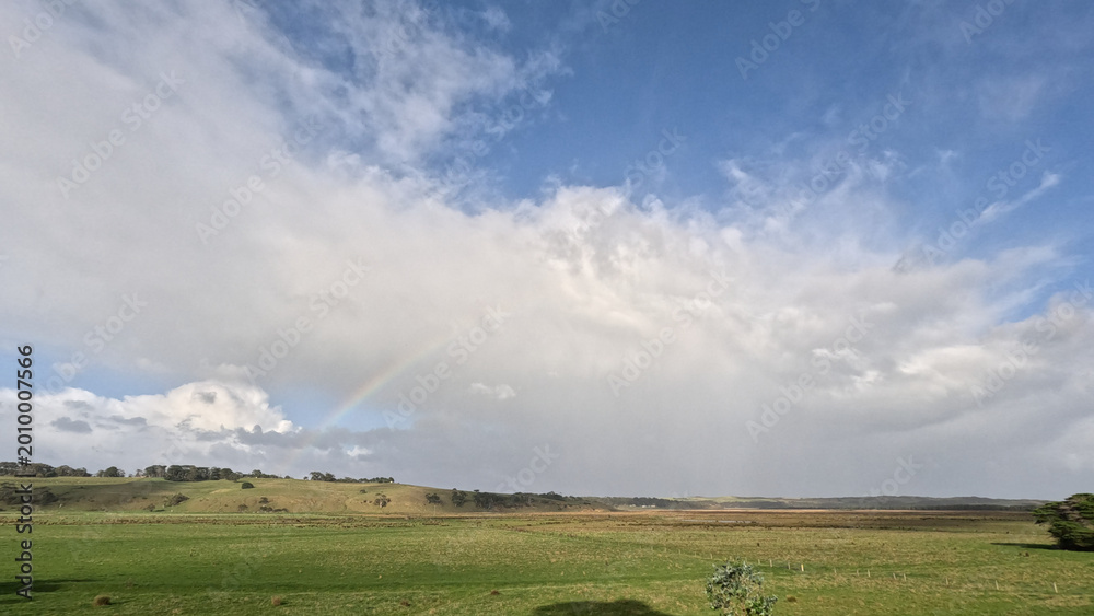 Fototapeta premium Scenic View of Green Hills and Rainbow Along Great Ocean Road