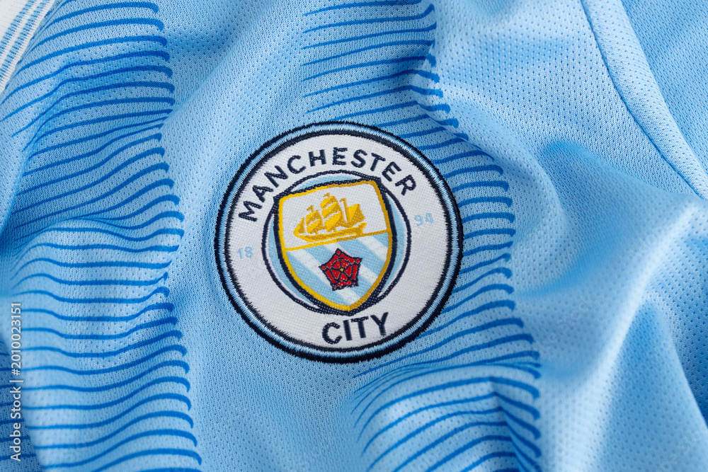 Fototapeta premium Kyiv, Ukraine, May 5, 2026. Close-up of Manchester City football jersey fabric with club crest logo texture