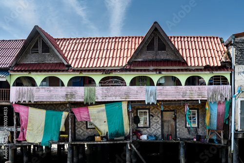 Tablou pe pânză Closeup of houses on the island of Koh Panyi, also known as Koh Panyee, Thailand, a small, Muslim fishing village notable for being built on stilts in the waters of Phang Nga Bay