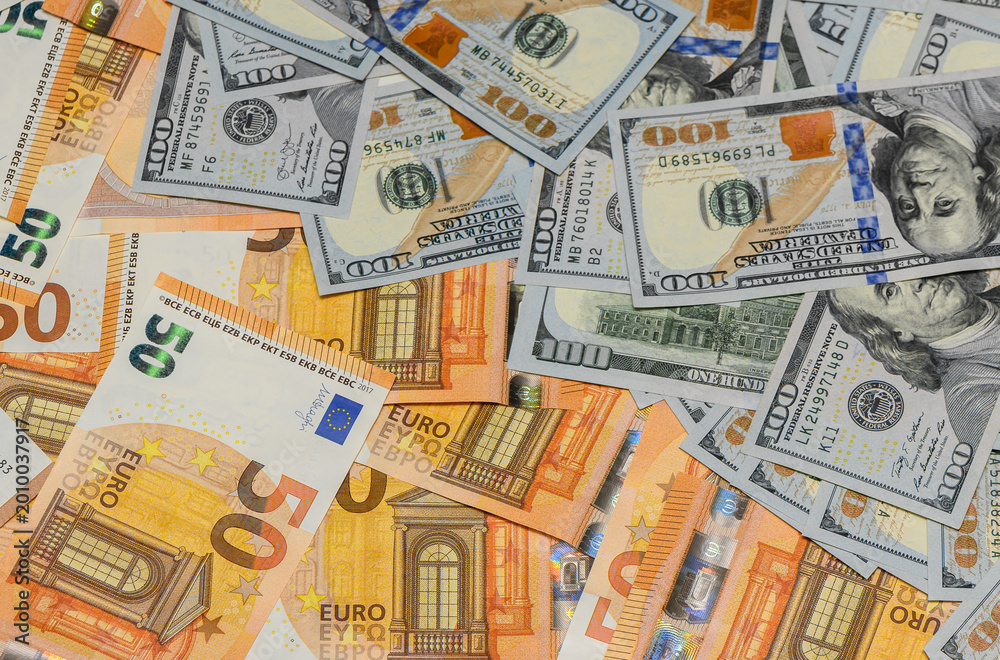 Obraz premium Hundred Dollar and Fifty Euro Banknotes as Money Background