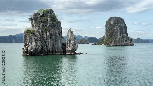 scenic limestone karst formations rising from tranquil emerald waters of ha long bay, vietnam landscape travel destination