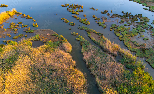Obraz na płótnie Beautiful aerial panorama of fragmented marsh islands basking in rich late after