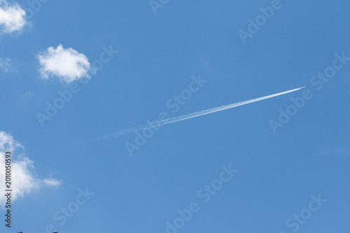 A jet aircraft flies high in the sky, powered by jet engines, often leaving a white contrail