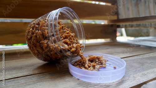 Photos Clear plastic container tipped on side spilling orek tempe