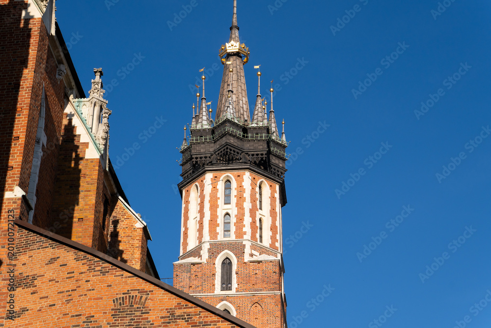 Obraz premium Spires of the Kosciol Mariacki, Bazylika Mariacka, (The St Mary Church, Saint Mary's Basilica) at the Main Market Square in Krakow, Krakow Old City, Krakow, Cracow, Poland