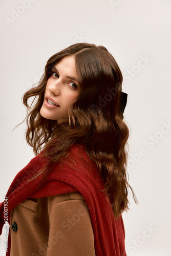 Canvas-taulu Chic young woman offering a captivating look while showcasing stylish winter fas
