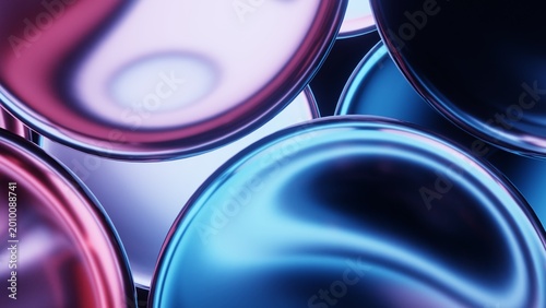 Close-up of glossy glass discs reflecting neon light