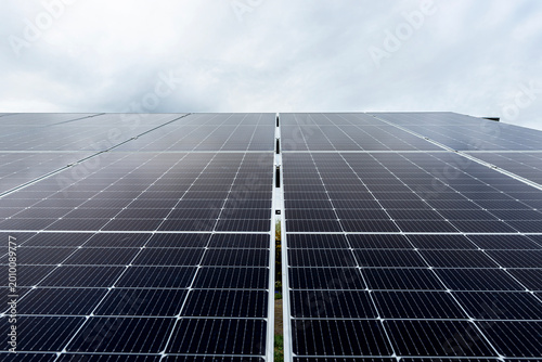 Solar panels generating clean energy under cloudy sky in poland