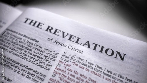 Book of revelation bible text macro moving camera scripture christian faith apocalyptic message spiritual religion background concept