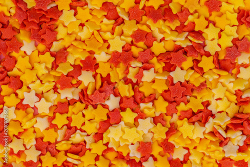 Bilde på lerret Colorful star-shaped sprinkles cover a surface for baking or decorating desserts