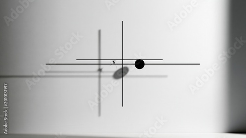 Minimalist clock with black hands and a round black center casting sharp shadows on a white wall.