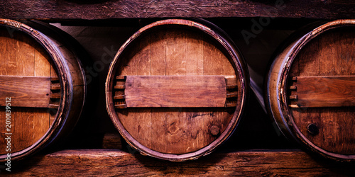 Bild auf Leinwand Wooden barrels stored in a cellar for aging wine and spirits