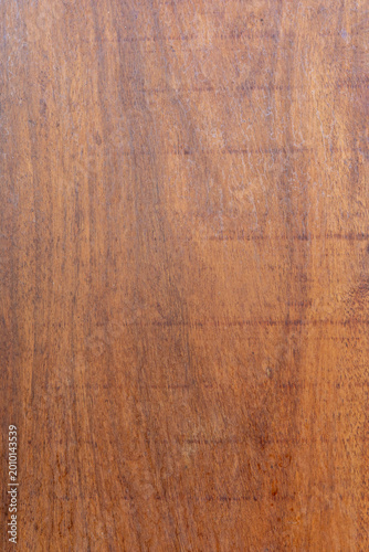 Photos Close up view of a polished mahogany wood surface showing natural grain and text
