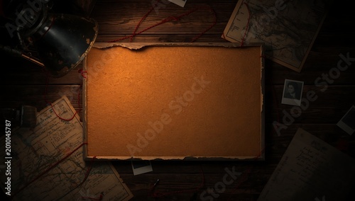Vintage Blank Parchment Illuminated by Desk Lamp on Dark Wooden Table.