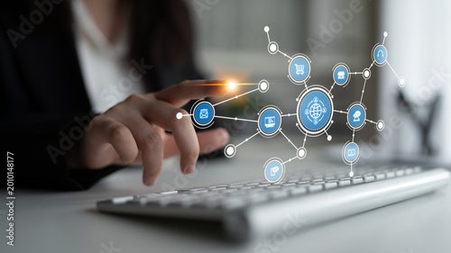 Konstfotografi A professional individual interacts with a keyboard while connected to digital network icons, showcasing modern technology and communication in a contemporary workspace