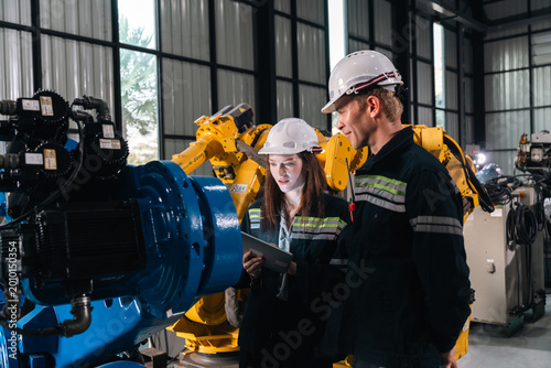 Cuadro en lienzo Repair specialist inspects machinery in factory ensuring industry standards are