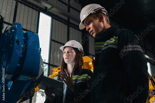 фотографія Repair specialist inspects machinery in factory ensuring industry standards are