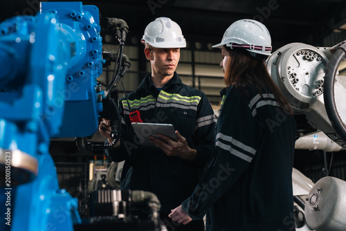 Bilde på lerret Repair specialist inspects machinery in factory ensuring industry standards are