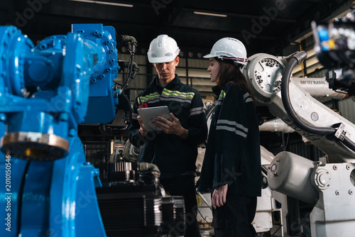 Fotografía Repair specialist inspects machinery in factory ensuring industry standards are