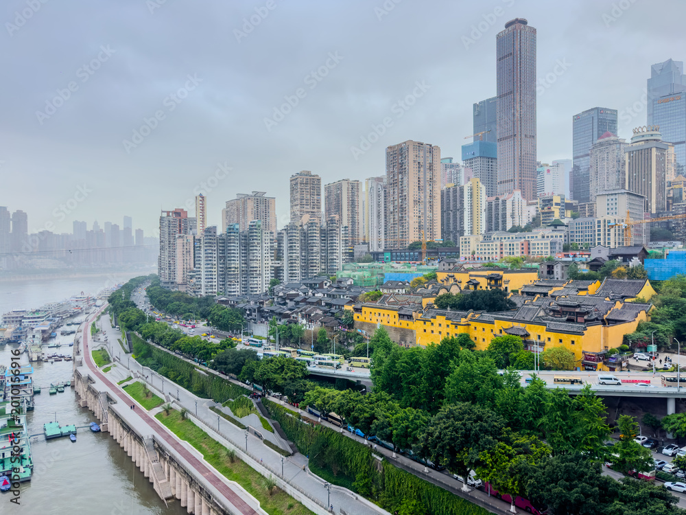 Fototapeta premium Chongqing China Metropolis filled with mountains and high-rise buildings on the Yangtze and Jialing Rivers. At night transforms into beautiful and colourful light shows on the river banks
