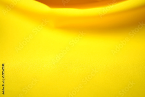 The yellow satin fabric rippled in waves.