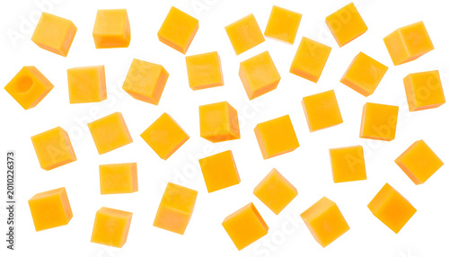 A flat-lay photograph showcases numerous, uniformly shaped, orange-colored cubes scattered on a black background. Each cube features a subtle yellow outline