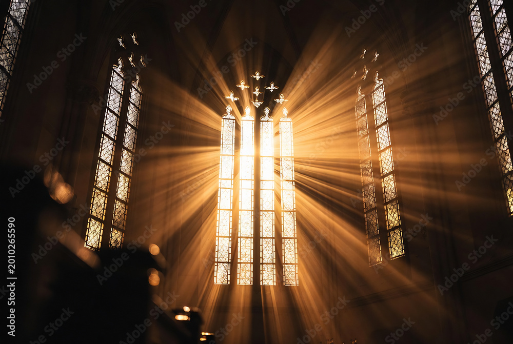 Fototapeta premium Subject: A stained-glass window in a cathedral. Action: Light streams through the windows, creating an ethereal effect. Setting: Inside a large, historic church.