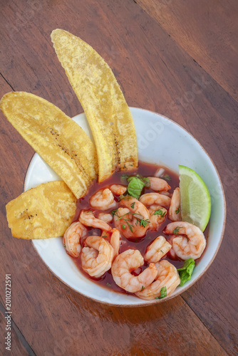 Fresh Shrimp Ceviche with Plantain Chips and Lime in a White Bowl