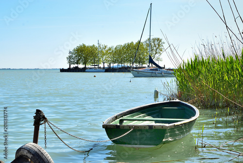 Obraz na płótnie Small green rowing boat moored by the shore of Lake Balaton near Révfülöp pier, Hungary