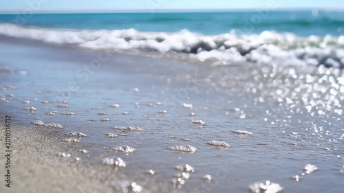 Gentle Ocean Waves Lapping on a Sandy Beach Shoreline 2.