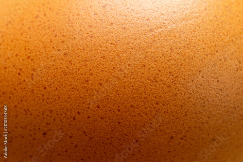 Extreme close-up of brown eggshell texture with natural speckles,Macro,A high-detailed macro shot revealing the intricate porous surface and organic brown patterns of a fresh chicken eggshell.