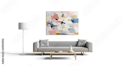 A modern living space featuring a neutral-toned sofa, a table, and a floor lamp. An abstract painting hangs above the couch