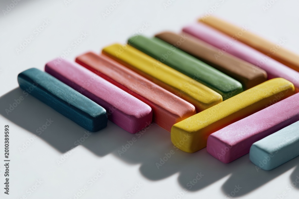 Fototapeta premium Colorful modeling clay sticks in diagonal rows on light surface