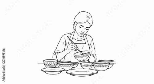 Woman paints decorative designs on ceramic bowls and plates