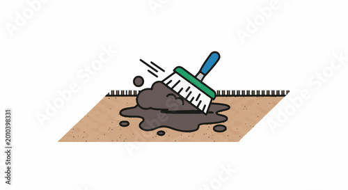 Brush sweeping dark mud and dirt onto sandy ground