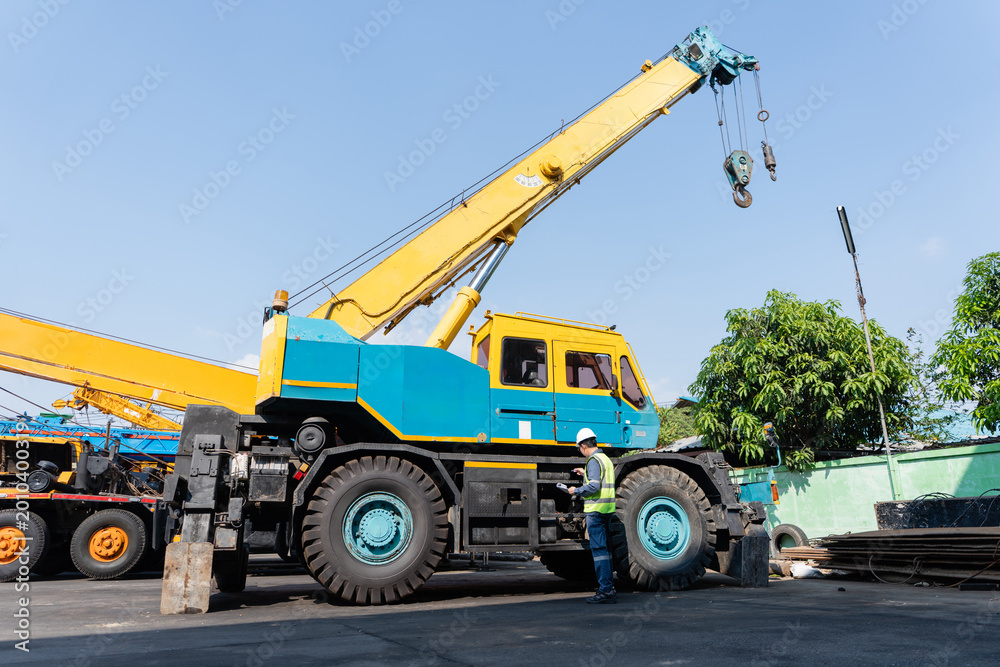Obraz premium Crane safety inspection mobile crane construction engineer worker Industrial crane safety inspection with construction worker checking mobile
