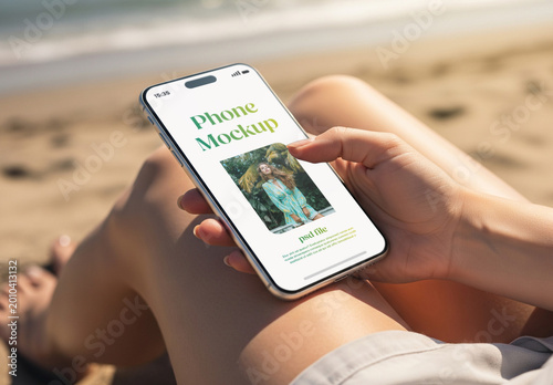 Woman holding a smartphone at the beach