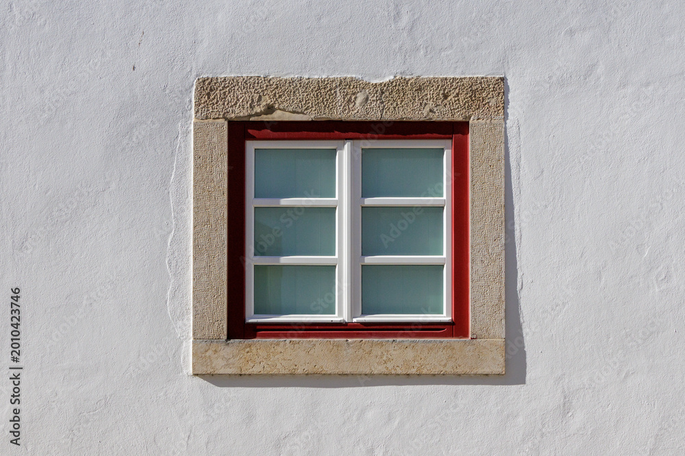 Fototapeta premium Traditional Portuguese window with red frame in Tomar