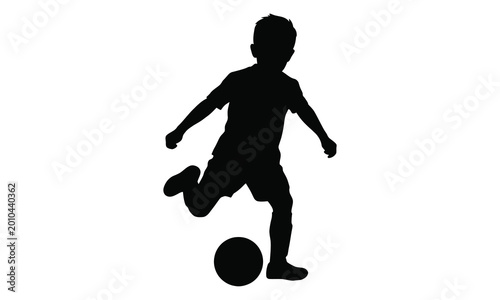 Silhouette of a young boy kicking a soccer ball, representing sports and active childhood