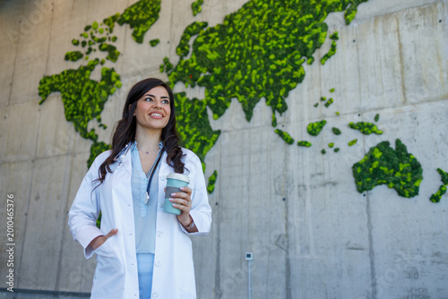 Female doctor holding coffee cup global healthcare sustainability