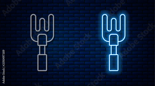 Photos Glowing neon line Garden rake icon isolated on brick wall background