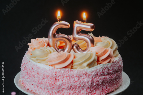 Quadro su tela Celebration cake for a milestone birthday 65 with candles shining bright