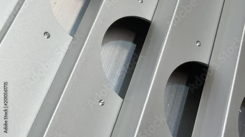 Aluminium facade profiles with meticulously drilled hinge holes, perfect for illustrating the precision and quality of construction materials in marketing materials.